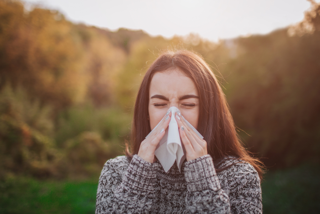 girl with allergies sneezing